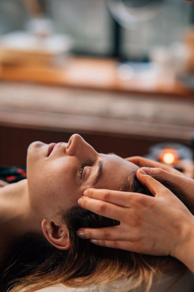 A therapist performing a relaxing head spa scalp treatment